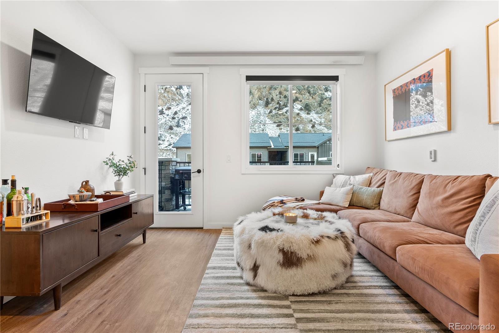 2155 Bighorn Road, Unit 201 Georgetown, CO 80444 - Photo 1 of 35 a living room with furniture a flat screen tv and a window