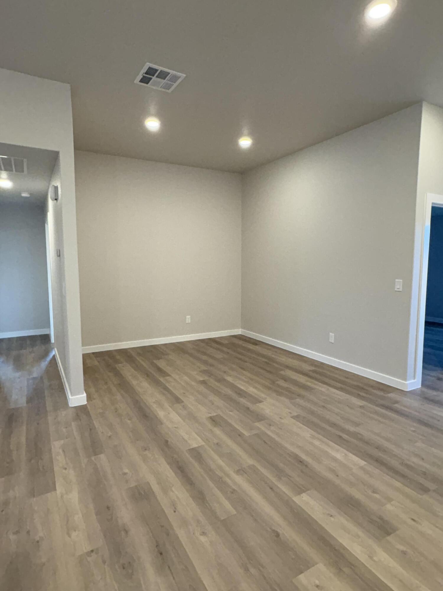 7222 35th Street Lubbock, TX 79407 - Photo 5 of 11 an empty room with wooden floor and windows