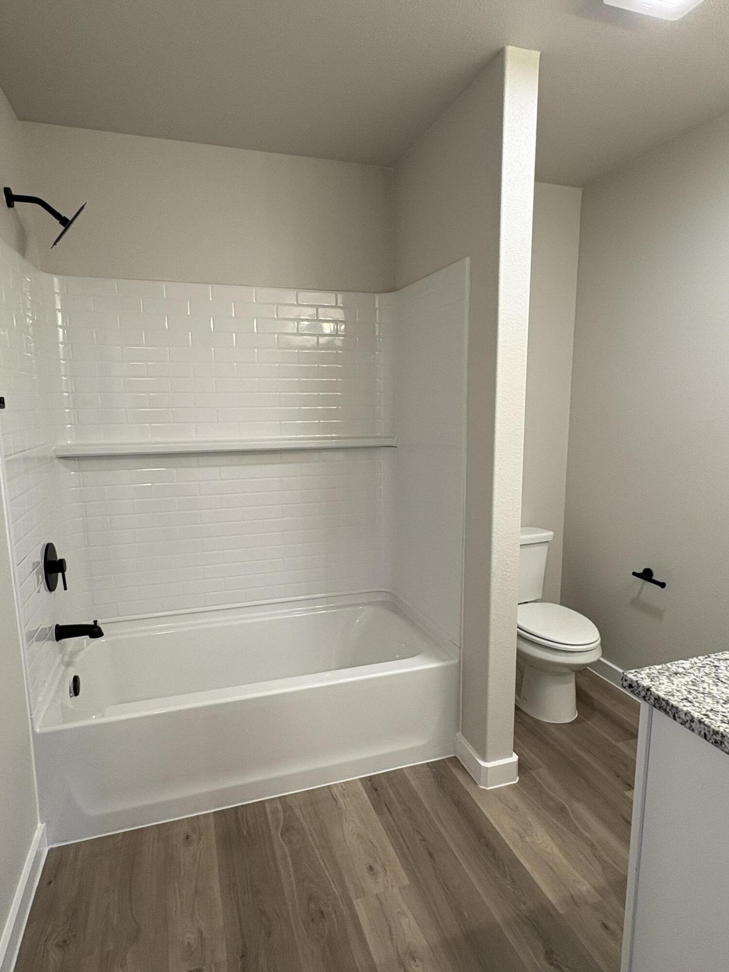 7222 35th Street Lubbock, TX 79407 - Photo 10 of 11 a bathroom with a bathtub and a toilet