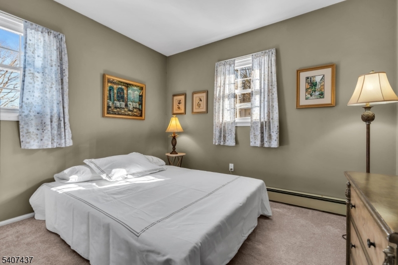 9 Corsica Road Hopatcong, NJ 07843 - Photo 21 of 33 a bedroom with a bed and a lamp on table