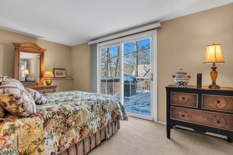 9 Corsica Road Hopatcong, NJ 07843 - Photo 8 of 33 a bedroom with a bed and large windows
