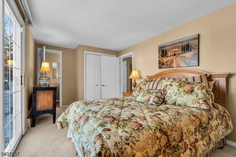 9 Corsica Road Hopatcong, NJ 07843 - Photo 10 of 33 a bedroom with a large bed and a chandelier