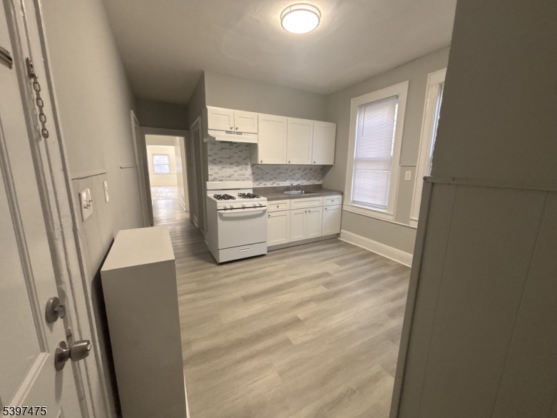 237 Fulton Street Paterson, NJ 07501 - Photo 7 of 11 a kitchen with stainless steel appliances a refrigerator and a stove