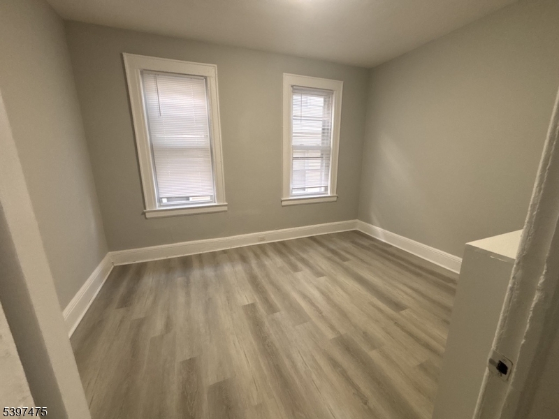 237 Fulton Street Paterson, NJ 07501 - Photo 9 of 11 a view of room with window and hardwood floor