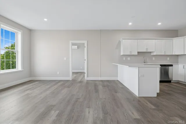 a view of kitchen with wooden floor and electronic appliances