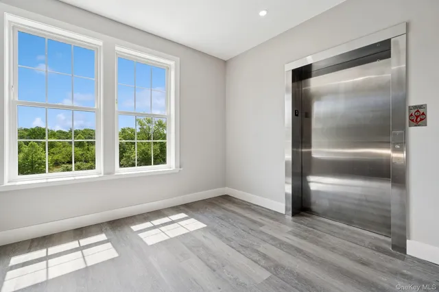 an empty room with windows and closet