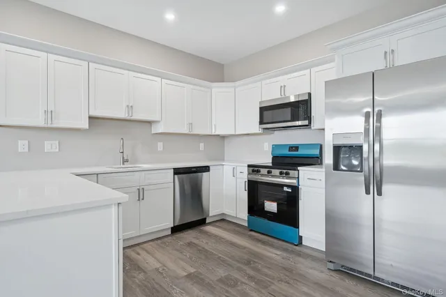 a kitchen with a sink stove and refrigerator