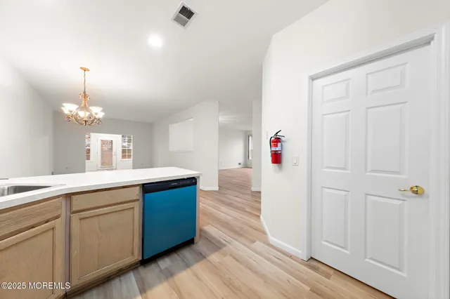a kitchen with a sink and chandelier