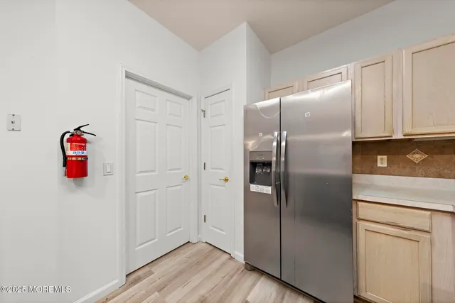 a kitchen with cabinets and stainless steel appliances