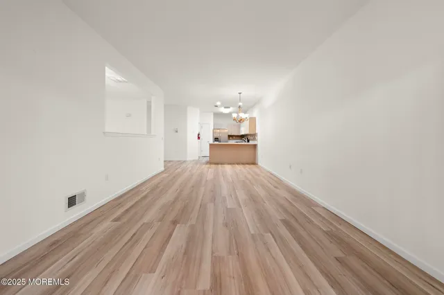 a view of a kitchen with wooden floor