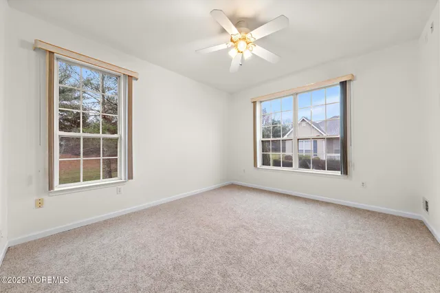an empty room with windows and closet