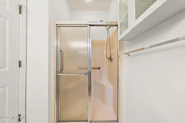 a bathroom with a glass shower door