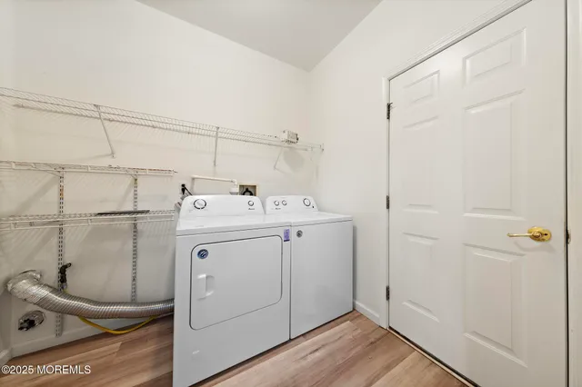 a utility room with cabinets washer and dryer