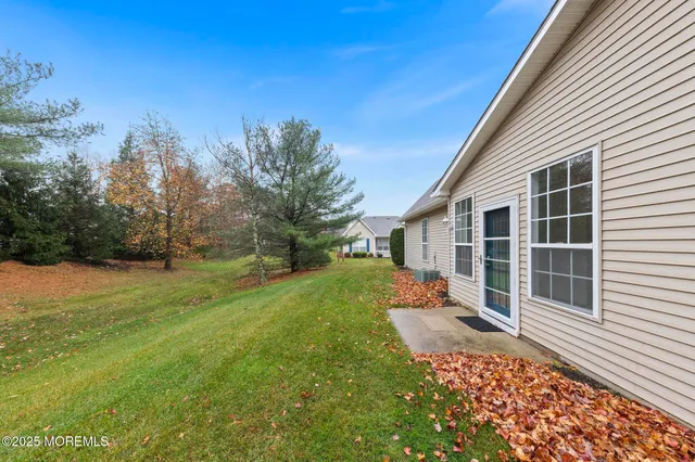 a backyard of a house with table and chairs