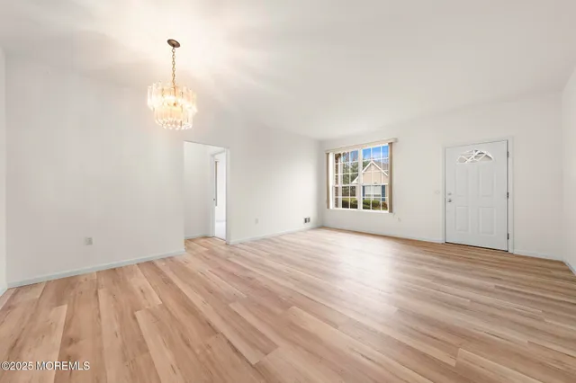 a view of empty room with wooden floor and stove