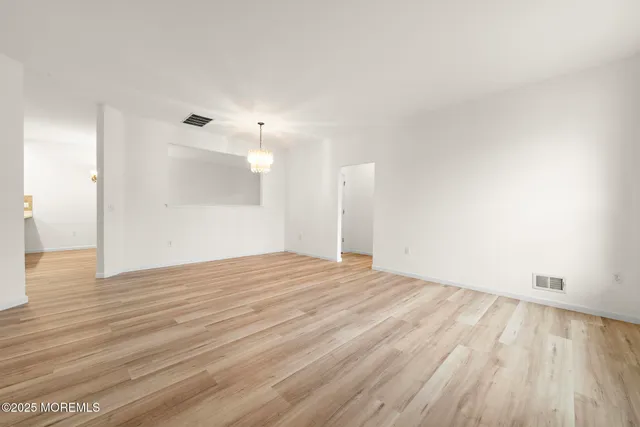 a view of an empty room and wooden floor