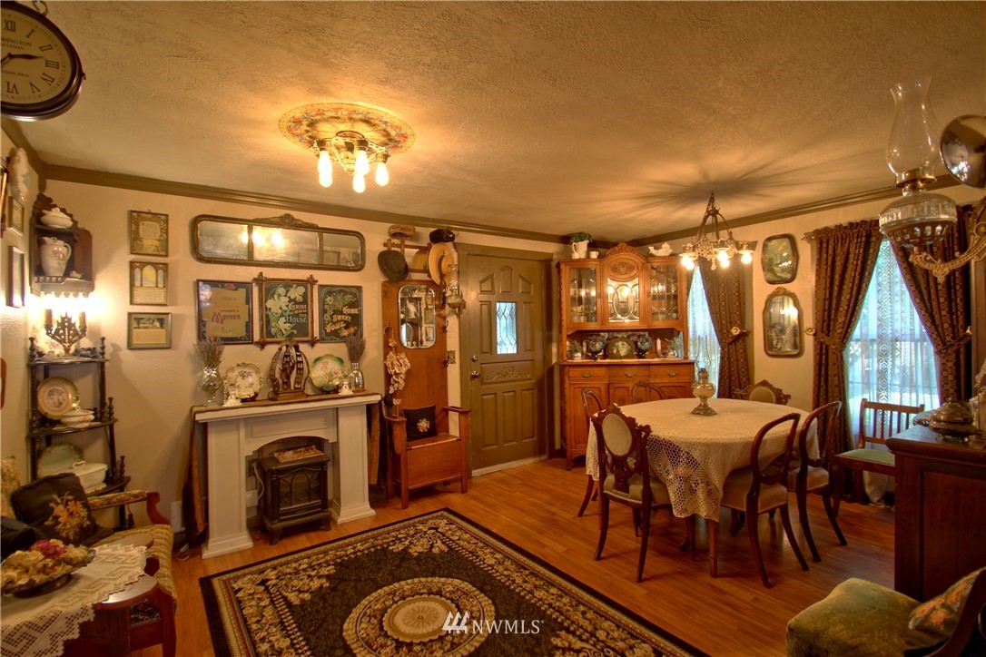 30217 Oso Loop Road Arlington, WA 98223 - Photo 20 of 34 a view of a dining room with furniture window and wooden floor