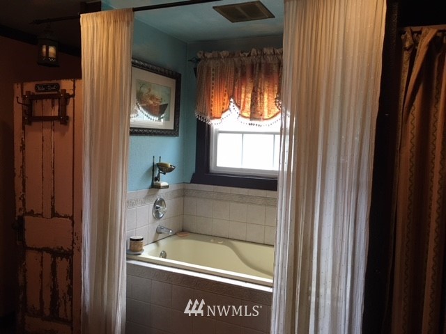 30217 Oso Loop Road Arlington, WA 98223 - Photo 26 of 34 a bathroom with a tub and shower