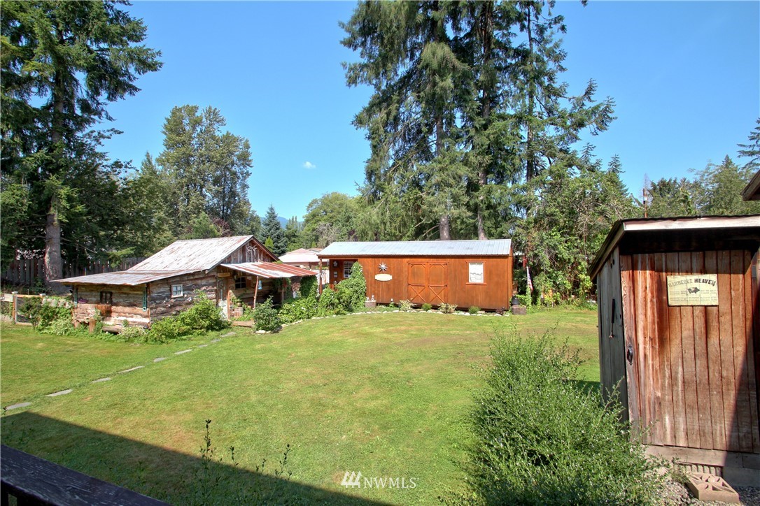 30217 Oso Loop Road Arlington, WA 98223 - Photo 5 of 34 a backyard of a house with table and chairs