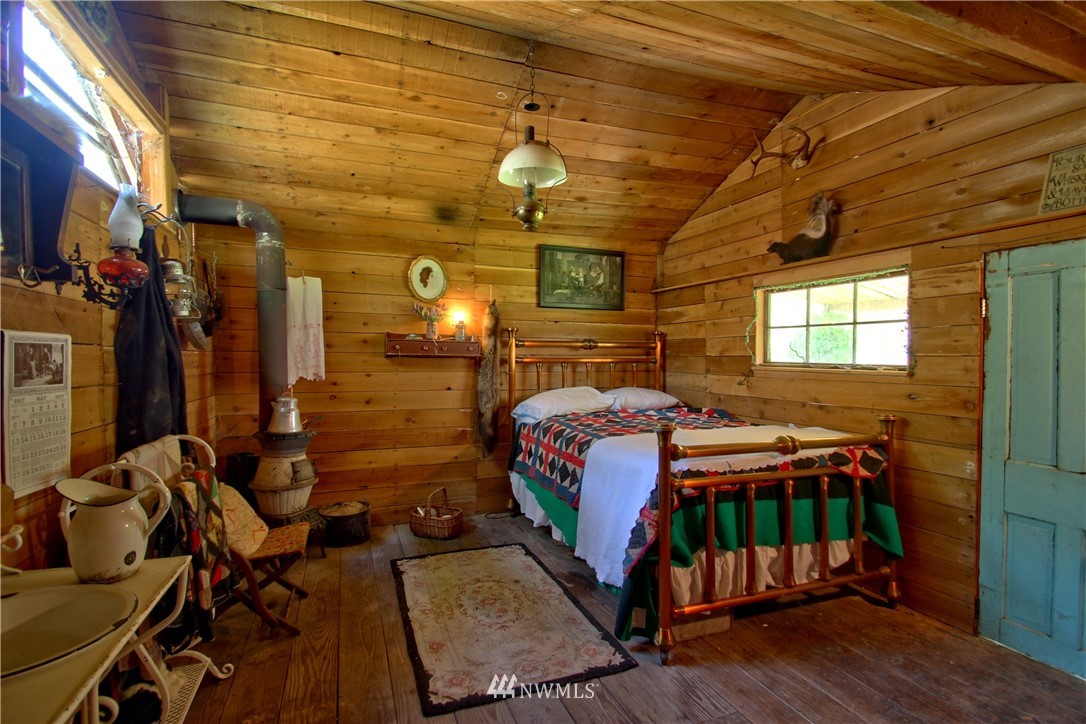 30217 Oso Loop Road Arlington, WA 98223 - Photo 8 of 34 a bedroom with a bed and wooden floor