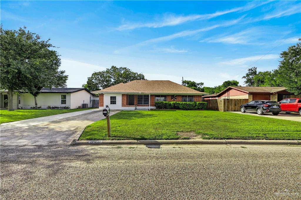 616 5th Street Weslaco, TX 78596 - Photo 17 of 33 a front view of a house with a yard