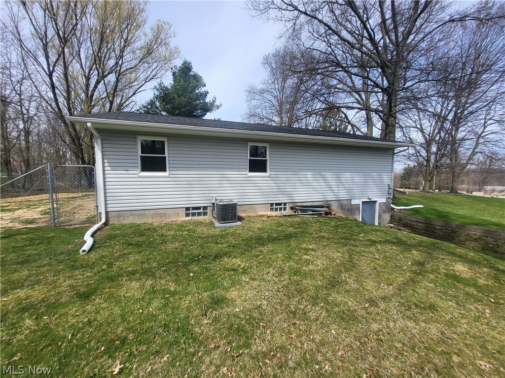 3260 Mogadore Road Akron, OH 44312 - Photo 15 of 20 Back of house with central AC unit and a lawn
