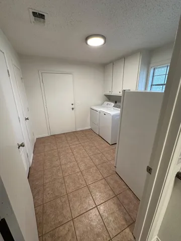 a room with a washing machine and a sink