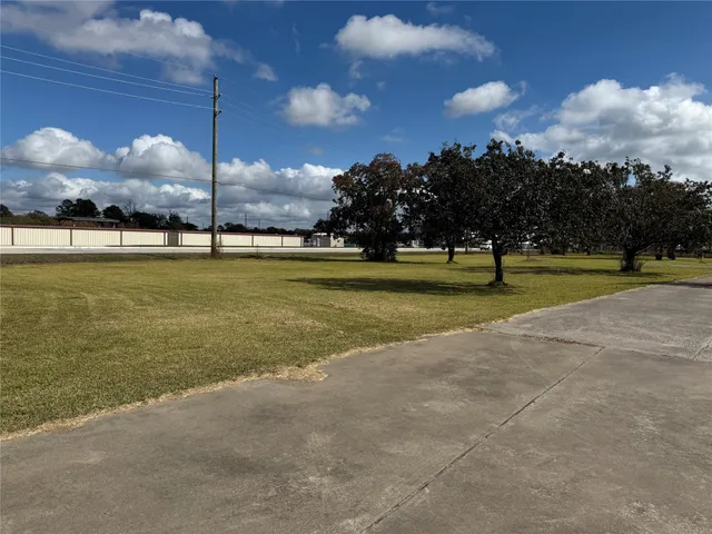 a view of an ocean with beach and trees in the background