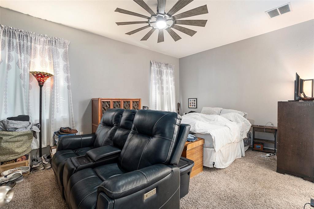 11808 Colony Lakes Boulevard New Port Richey, FL 34654 - Photo 11 of 25 a living room with furniture ceiling fan and a window