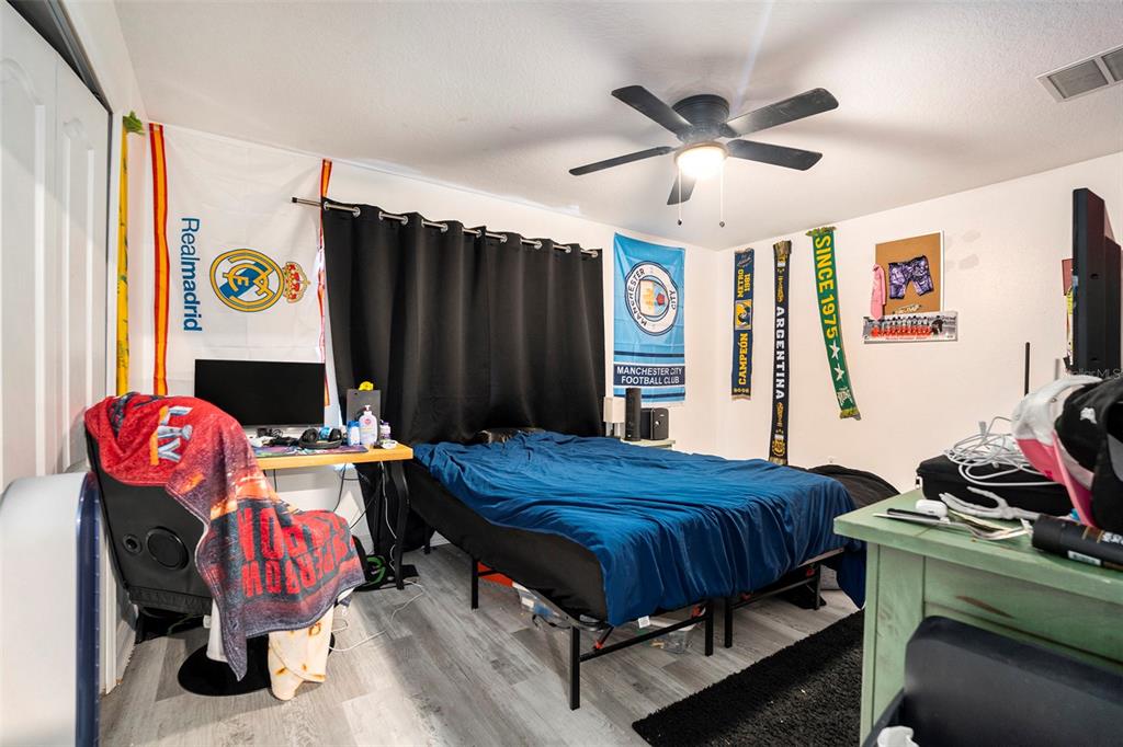 11808 Colony Lakes Boulevard New Port Richey, FL 34654 - Photo 15 of 25 a bedroom with a bed and dresser