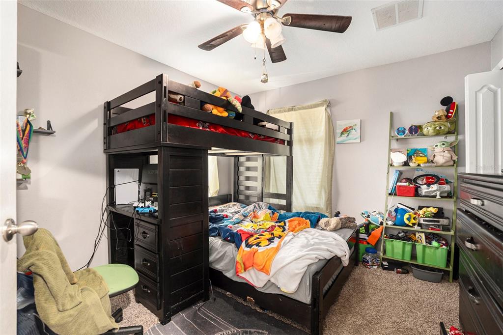 11808 Colony Lakes Boulevard New Port Richey, FL 34654 - Photo 20 of 25 a bedroom with a bed and wooden floor