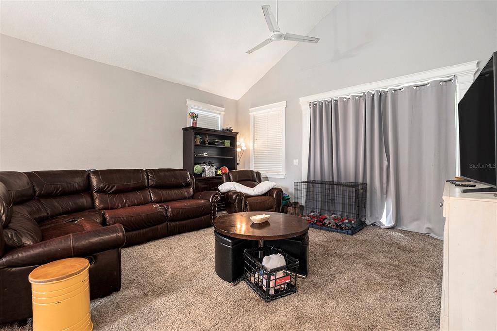 11808 Colony Lakes Boulevard New Port Richey, FL 34654 - Photo 5 of 25 a living room with furniture and a flat screen tv
