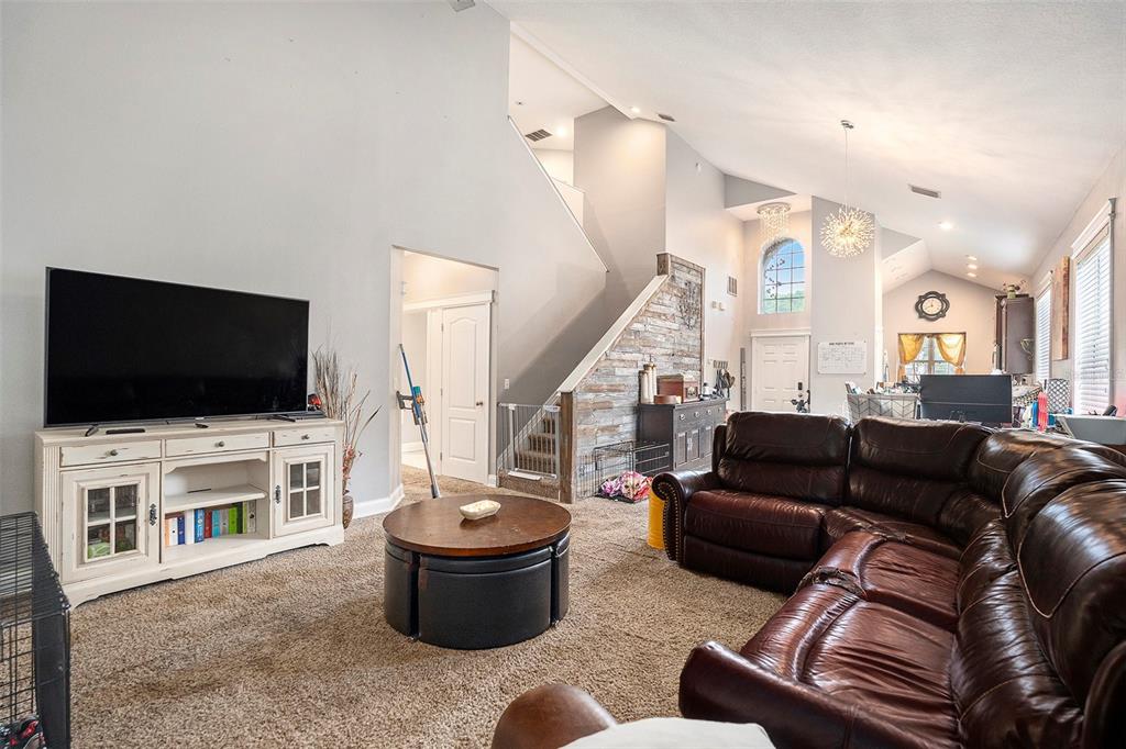 11808 Colony Lakes Boulevard New Port Richey, FL 34654 - Photo 7 of 25 a living room with furniture and a flat screen tv