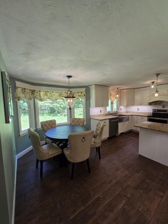 8 Caleb Road Shirley, MA 01464 - Photo 11 of 42 a living room with a table chairs and a dining table with wooden floor
