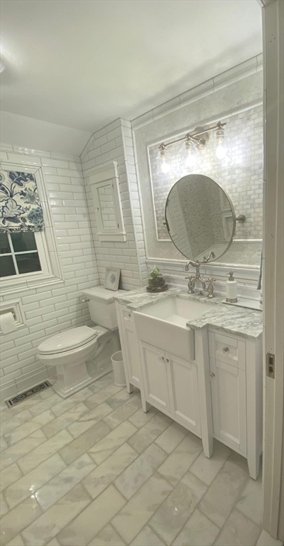 8 Caleb Road Shirley, MA 01464 - Photo 13 of 42 a bathroom with a double vanity sink toilet and mirror
