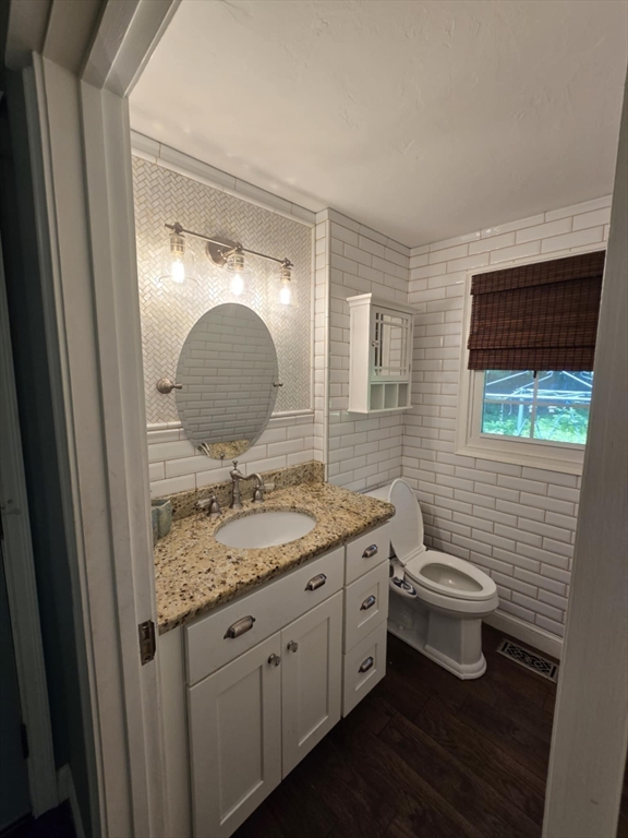 8 Caleb Road Shirley, MA 01464 - Photo 18 of 42 a bathroom with a granite countertop toilet sink and mirror