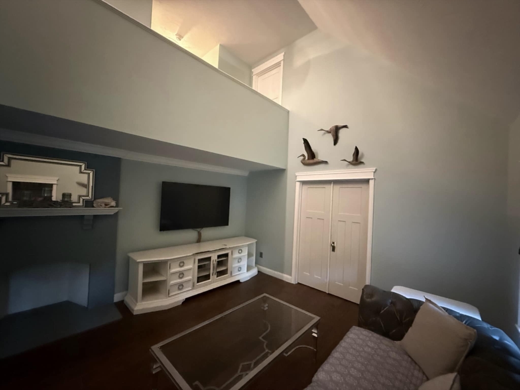 8 Caleb Road Shirley, MA 01464 - Photo 19 of 42 a living room with furniture and a flat screen tv