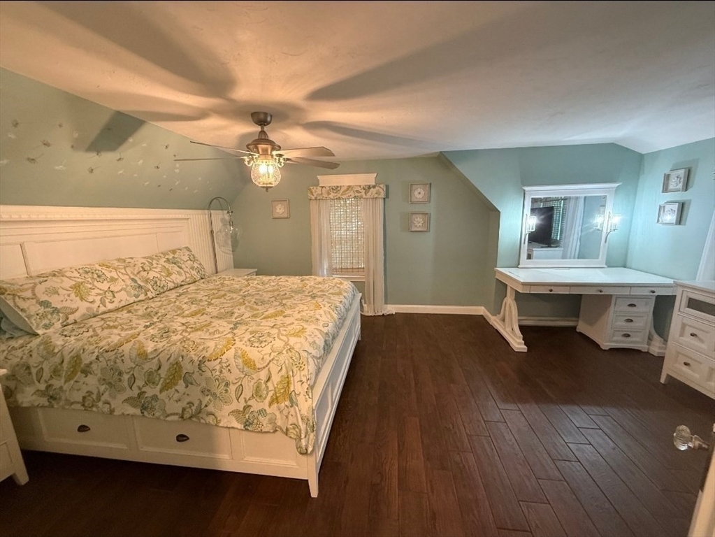 8 Caleb Road Shirley, MA 01464 - Photo 34 of 42 a bedroom with a bed and a chandelier