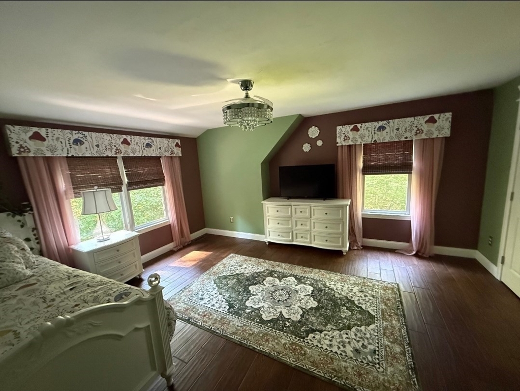 8 Caleb Road Shirley, MA 01464 - Photo 40 of 42 a living room with a fireplace and a flat screen tv