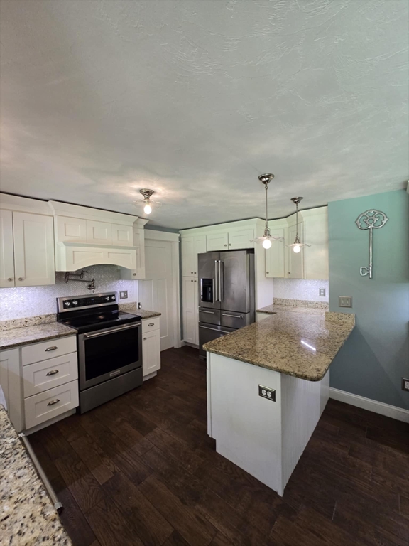8 Caleb Road Shirley, MA 01464 - Photo 7 of 42 a kitchen with granite countertop a sink and stainless steel appliances