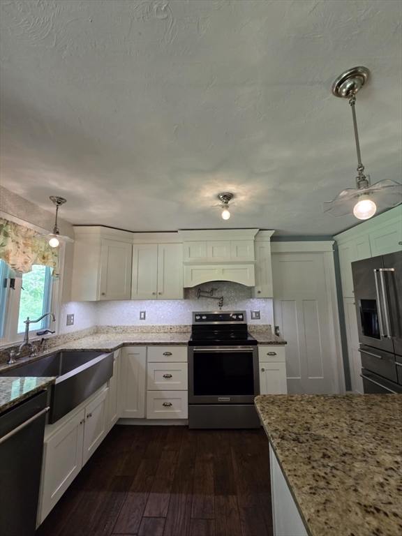 8 Caleb Road Shirley, MA 01464 - Photo 8 of 42 a kitchen with stainless steel appliances granite countertop a sink stove and refrigerator