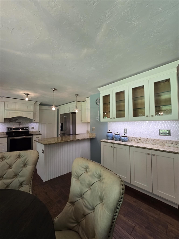 8 Caleb Road Shirley, MA 01464 - Photo 9 of 42 a kitchen with granite countertop a stove and cabinets