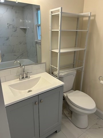 1599 Washington Street, Unit 2 Newton, MA 02465 - Photo 14 of 34 a bathroom with a sink a toilet and a mirror