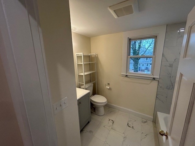 1599 Washington Street, Unit 2 Newton, MA 02465 - Photo 15 of 34 a bathroom with a granite countertop toilet and a shower