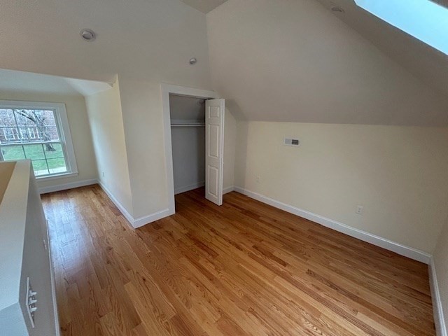 1599 Washington Street, Unit 2 Newton, MA 02465 - Photo 26 of 34 an empty room with wooden floor and windows