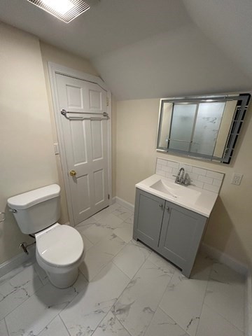 1599 Washington Street, Unit 2 Newton, MA 02465 - Photo 28 of 34 a white toilet sitting next to a bathroom sink