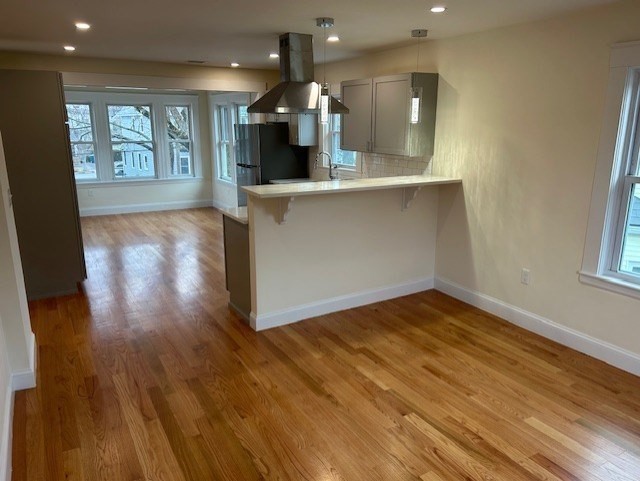 1599 Washington Street, Unit 2 Newton, MA 02465 - Photo 7 of 34 wooden floor in an empty room with a window