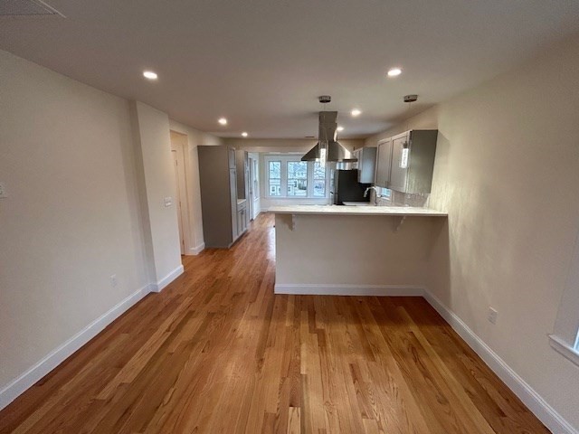 1599 Washington Street, Unit 2 Newton, MA 02465 - Photo 9 of 34 a view of kitchen with wooden floor and electronic appliances