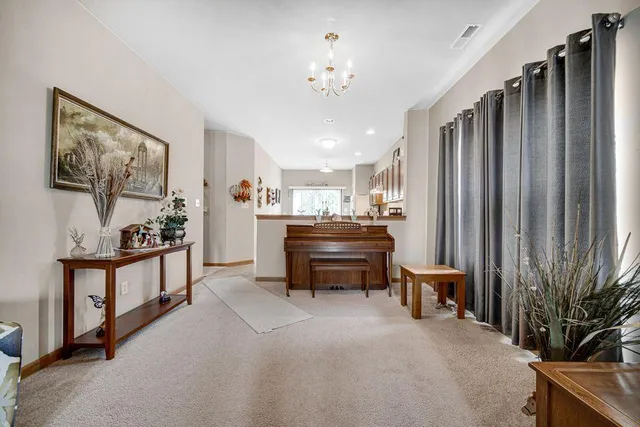 a living room with furniture and a piano