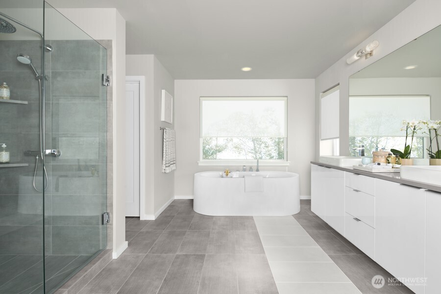3924 190th Street Southeast Bothell, WA 98012 - Photo 11 of 12 a large white bathroom with a granite countertop shower a sink and a mirror
